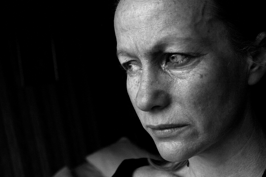 black and white image of a sad woman, conceptual domestic violence, mental health, depression