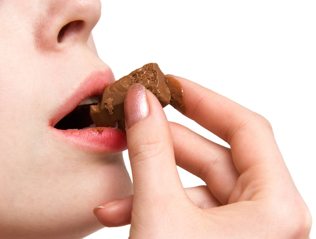 This image has an empty alt attribute; its file name is bigstock-Girl-eating-chocolate-Isolate-15366437-1024x774.jpg