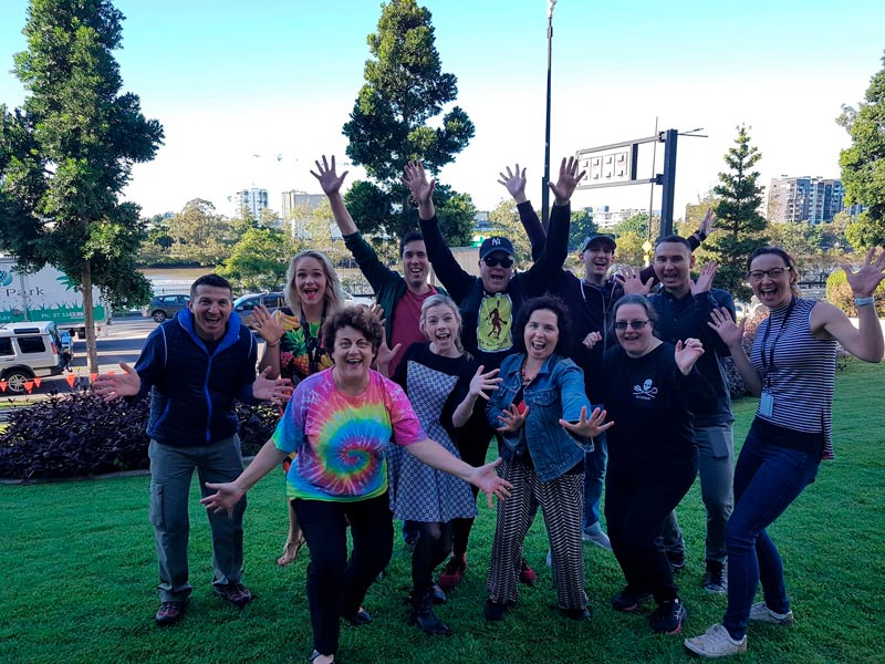 A group of people in a pose with Heather Joy all smiling with hands out