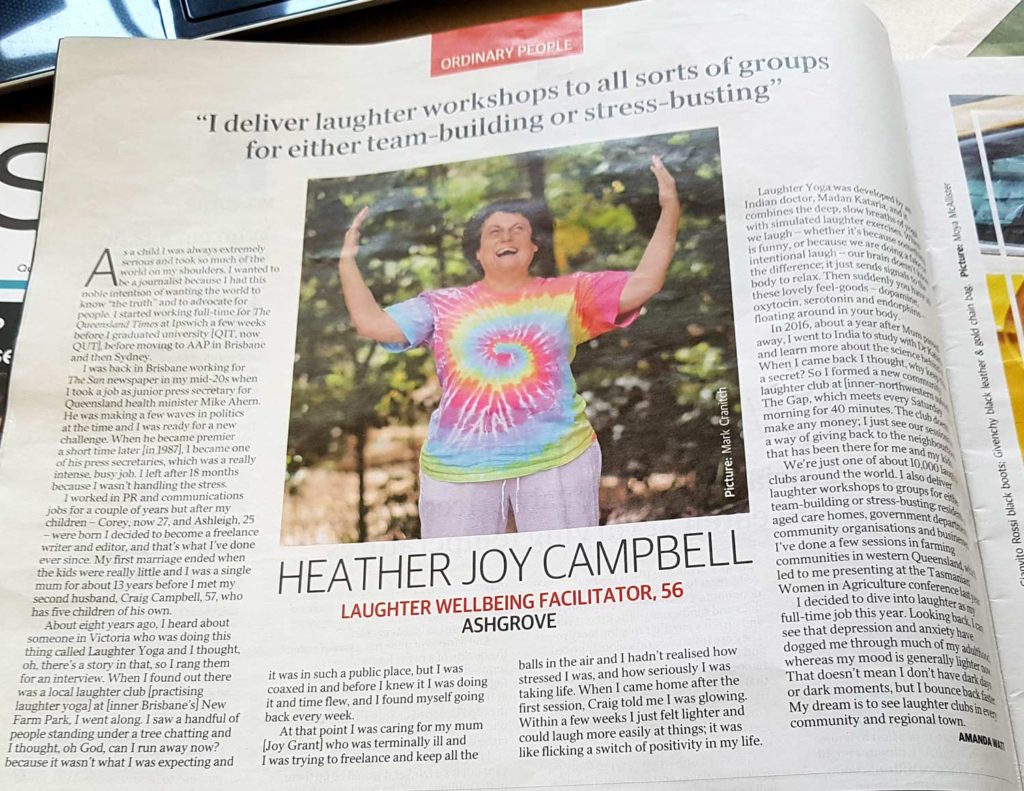 A newspaper article with a photo of Heather Joy wearing a bright rainbow coloured tshirt