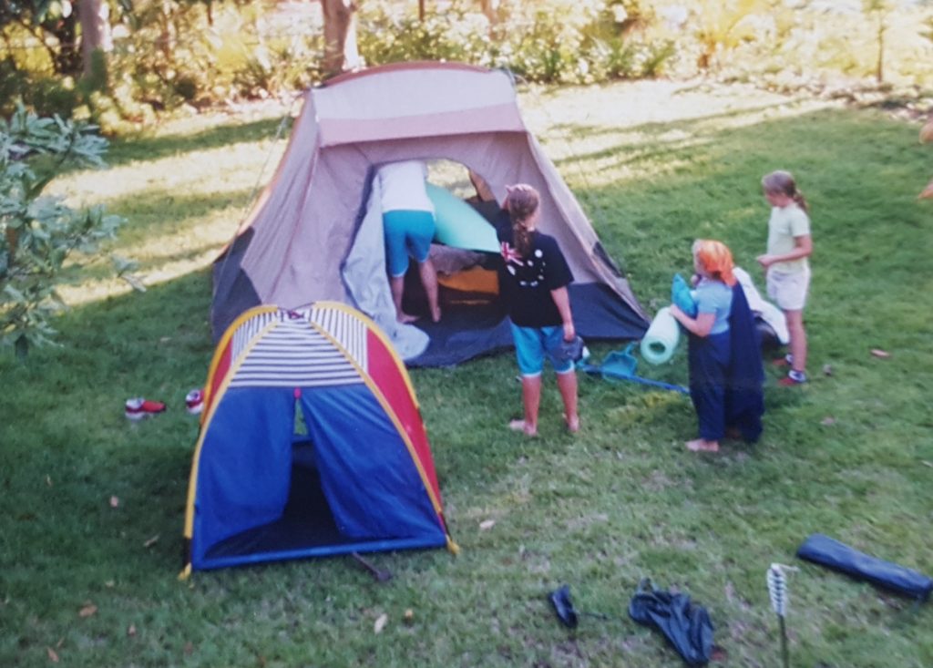 children set up a tent in the backyard