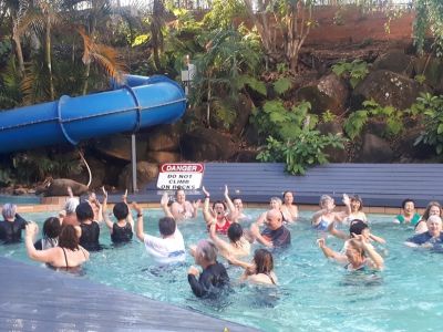 People in a pool doing aqua laughter class